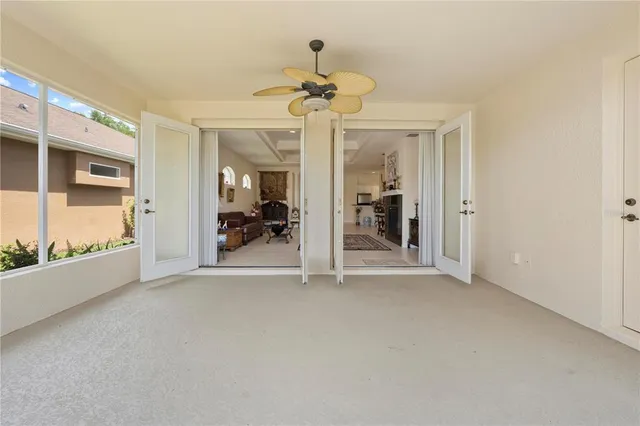 a view of an empty room with a floor to ceiling window and yard