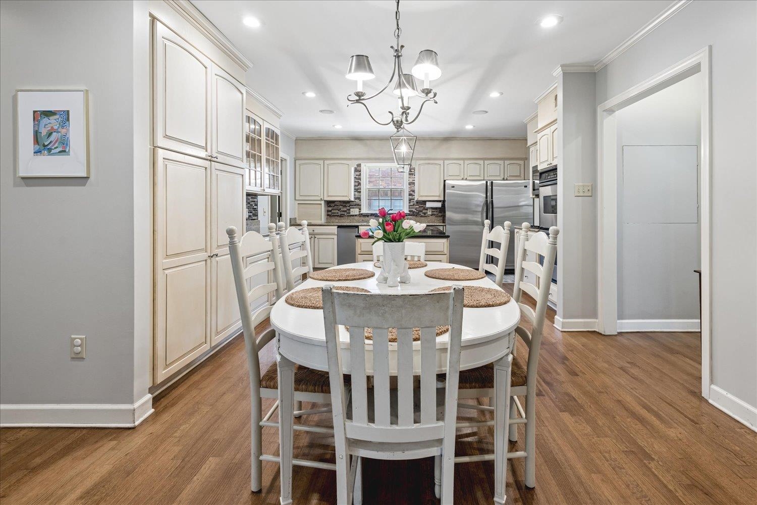 5311 South Angela Road Memphis, TN 38120 - Photo 14 of 40 a view of a dining room with furniture a chandelier and wooden floor