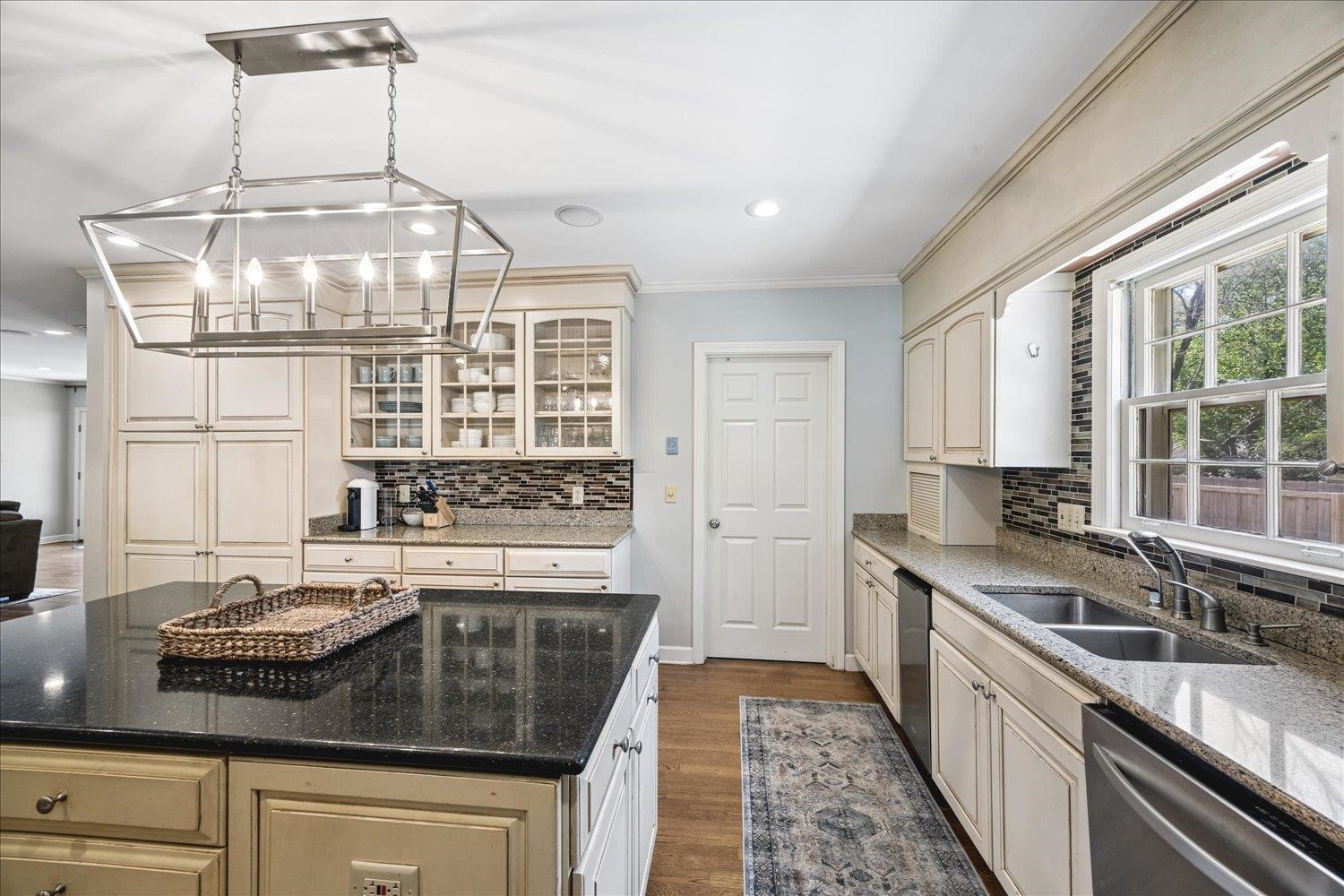 5311 South Angela Road Memphis, TN 38120 - Photo 16 of 40 a kitchen with a sink stove and cabinets