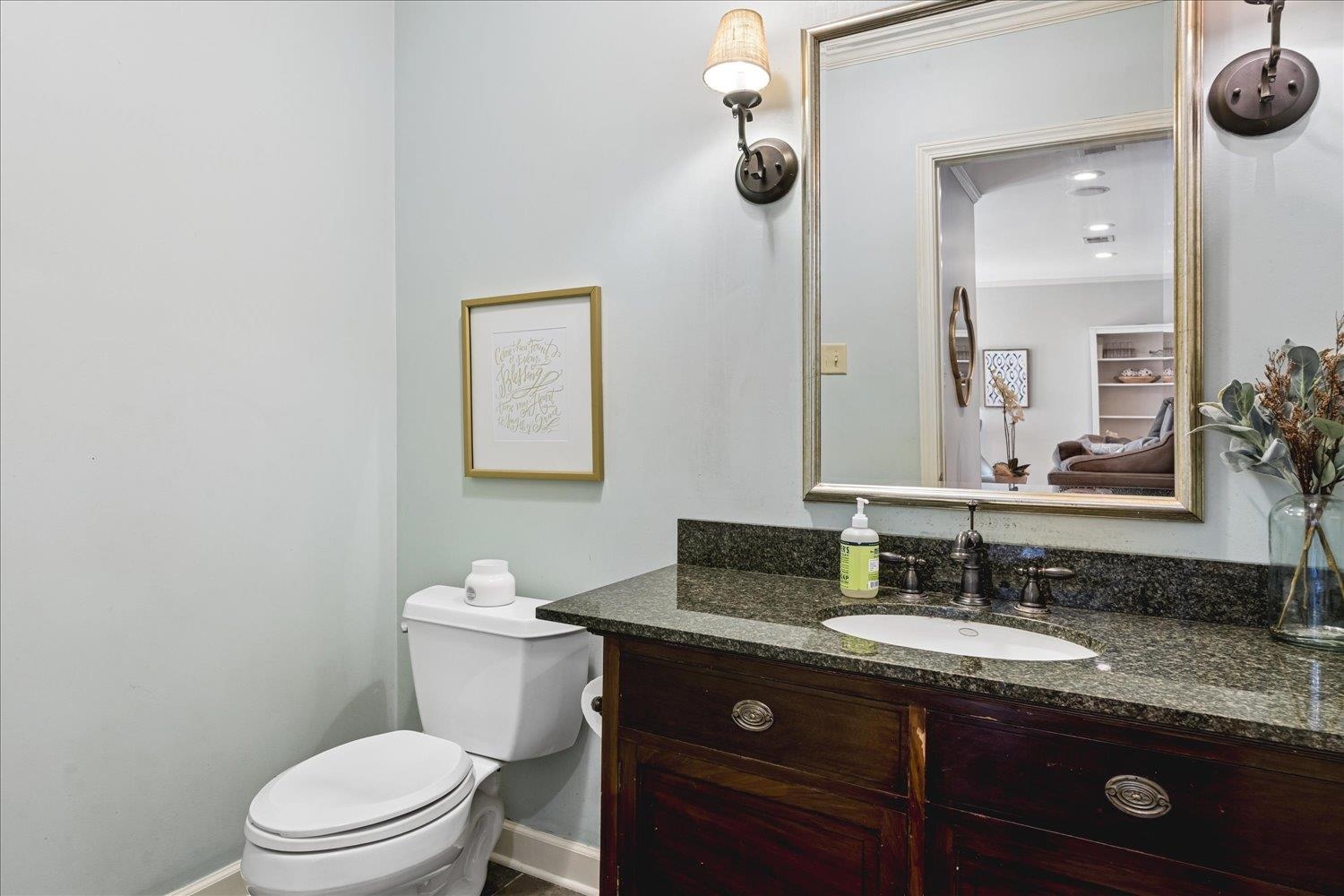 5311 South Angela Road Memphis, TN 38120 - Photo 18 of 40 a bathroom with a granite countertop sink a mirror and a toilet