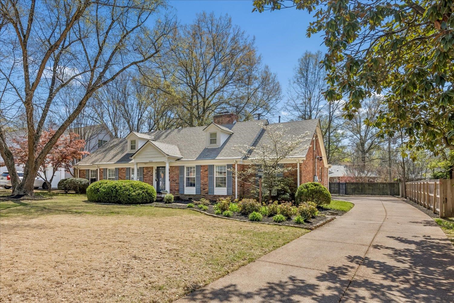 5311 South Angela Road Memphis, TN 38120 - Photo 3 of 40 a front view of a house with a yard and potted plants