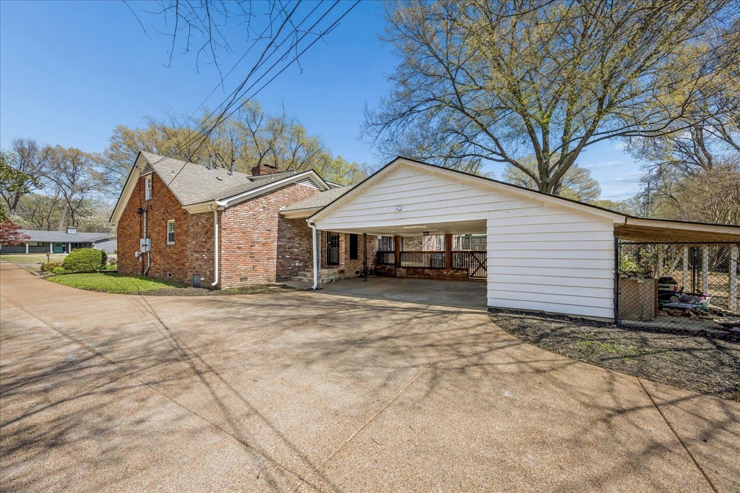 5311 South Angela Road Memphis, TN 38120 - Photo 38 of 40 a front view of a house with a yard and garage