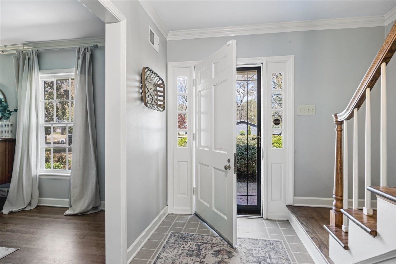 5311 South Angela Road Memphis, TN 38120 - Photo 6 of 40 a view of an entryway with wooden floor and windows