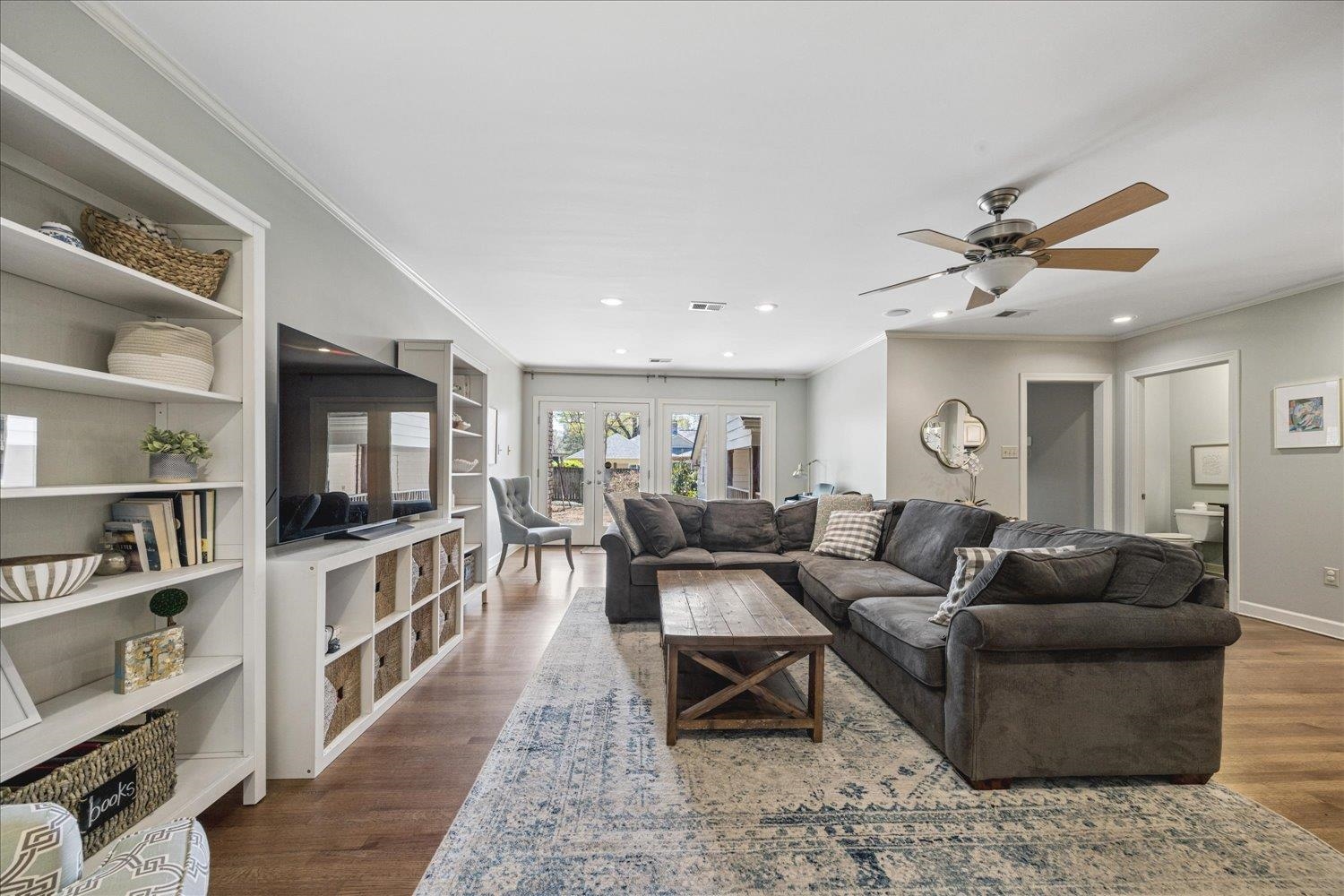 5311 South Angela Road Memphis, TN 38120 - Photo 10 of 40 a living room with furniture a flat screen tv and a book shelf