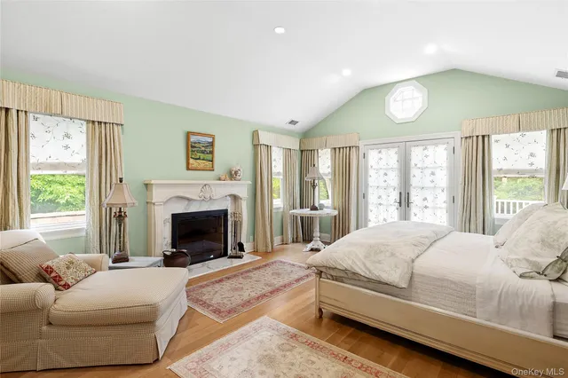 a spacious bedroom with a large bed and a fireplace