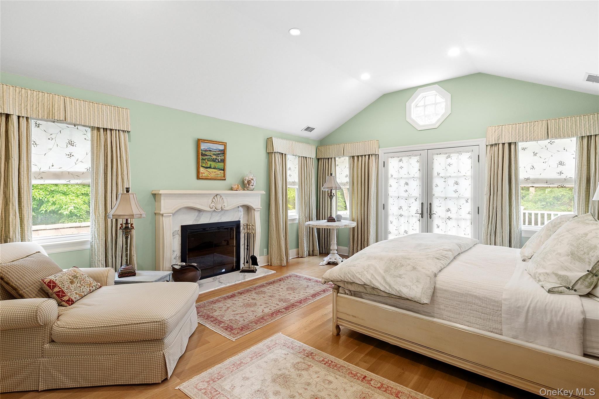 55 Cedar Lane West Remsenburg, NY 11960 - Photo 12 of 27 a spacious bedroom with a large bed and a fireplace