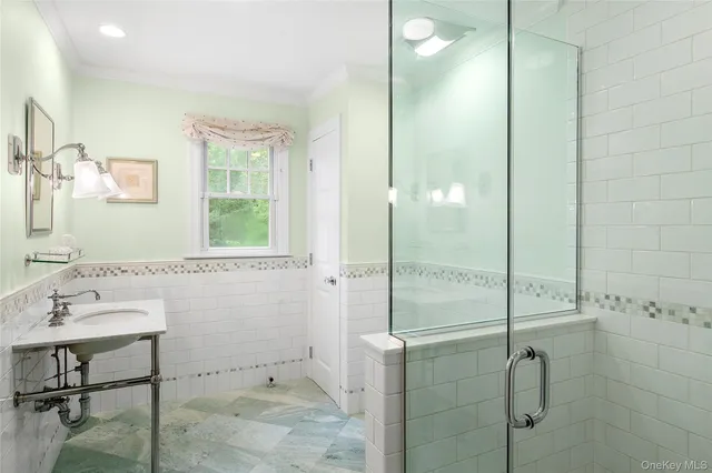 a bathroom with a shower and a sink