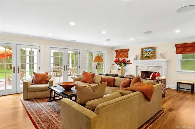 a living room with furniture large window and a fireplace