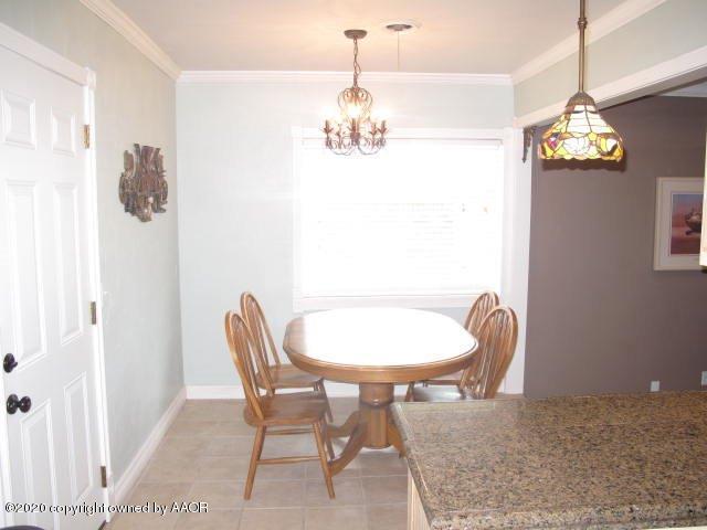 4211 Gary Lane Amarillo, TX 79110 - Photo 9 of 23 a dining room with furniture a chandelier and window