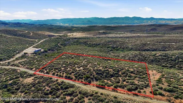 a view of a field with an ocean view