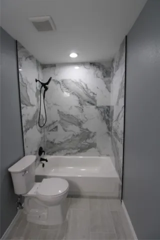 a bathroom with a double vanity sink a toilet and mirror