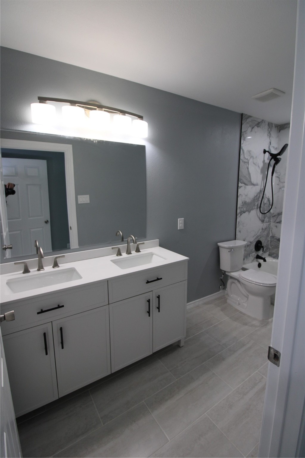 503 Austin Street Brazoria, TX 77422 - Photo 14 of 24 a bathroom with a double vanity sink a toilet and mirror