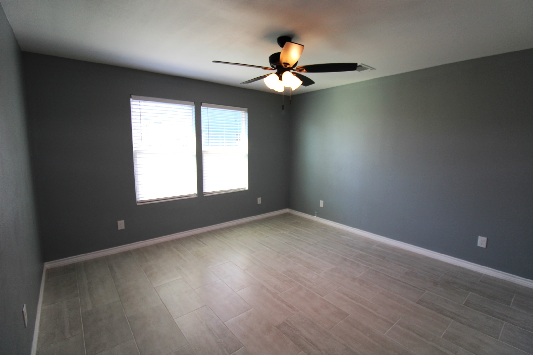 503 Austin Street Brazoria, TX 77422 - Photo 16 of 24 an empty room with windows and fan