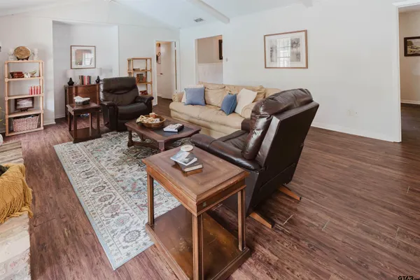 a living room with furniture and wooden floor