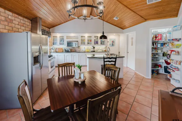 a dinning table and chairs in a open kitchen