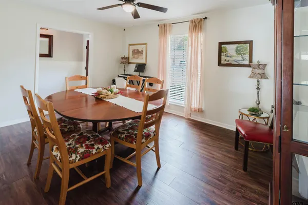 a dining room with furniture and wooden floor
