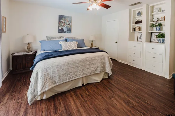 a bedroom with a bed and painting on the wall