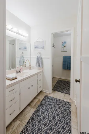 a spacious bathroom with a double vanity sink a mirror and a shower