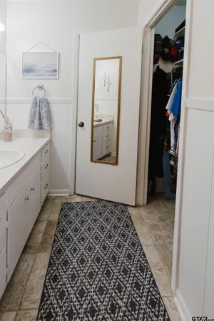 a room with a walk in closet and a mirror