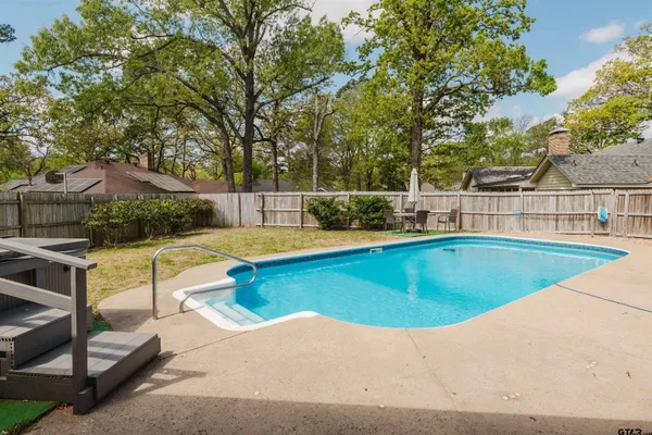 a view of a swimming pool with chairs