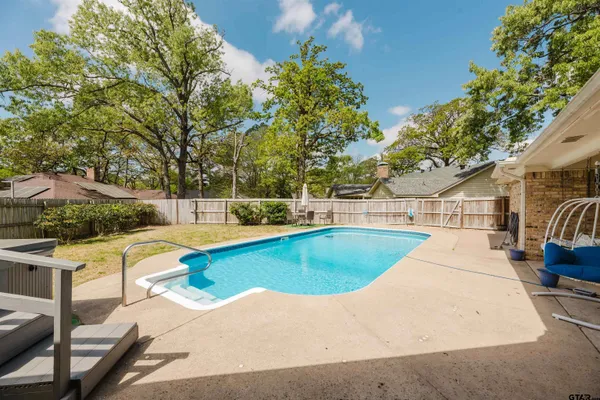 a view of a swimming pool with a patio