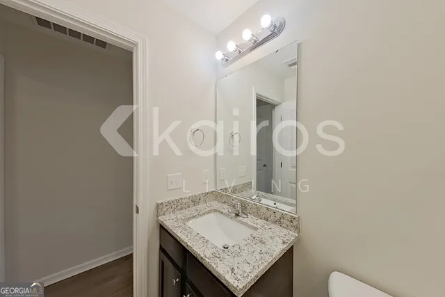 a bathroom with a sink vanity and a mirror