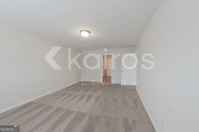 a view of a room with wooden floor and white walls