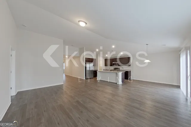 a view of kitchen and hall with wooden floor