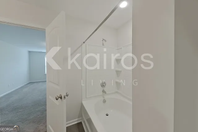 a bathroom with a bathtub and shower