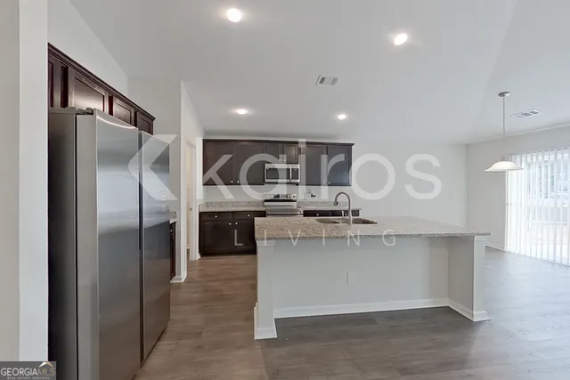 a kitchen with a refrigerator and a sink