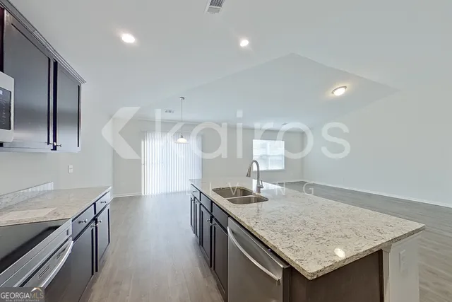 a kitchen with stainless steel appliances granite countertop a sink and stove