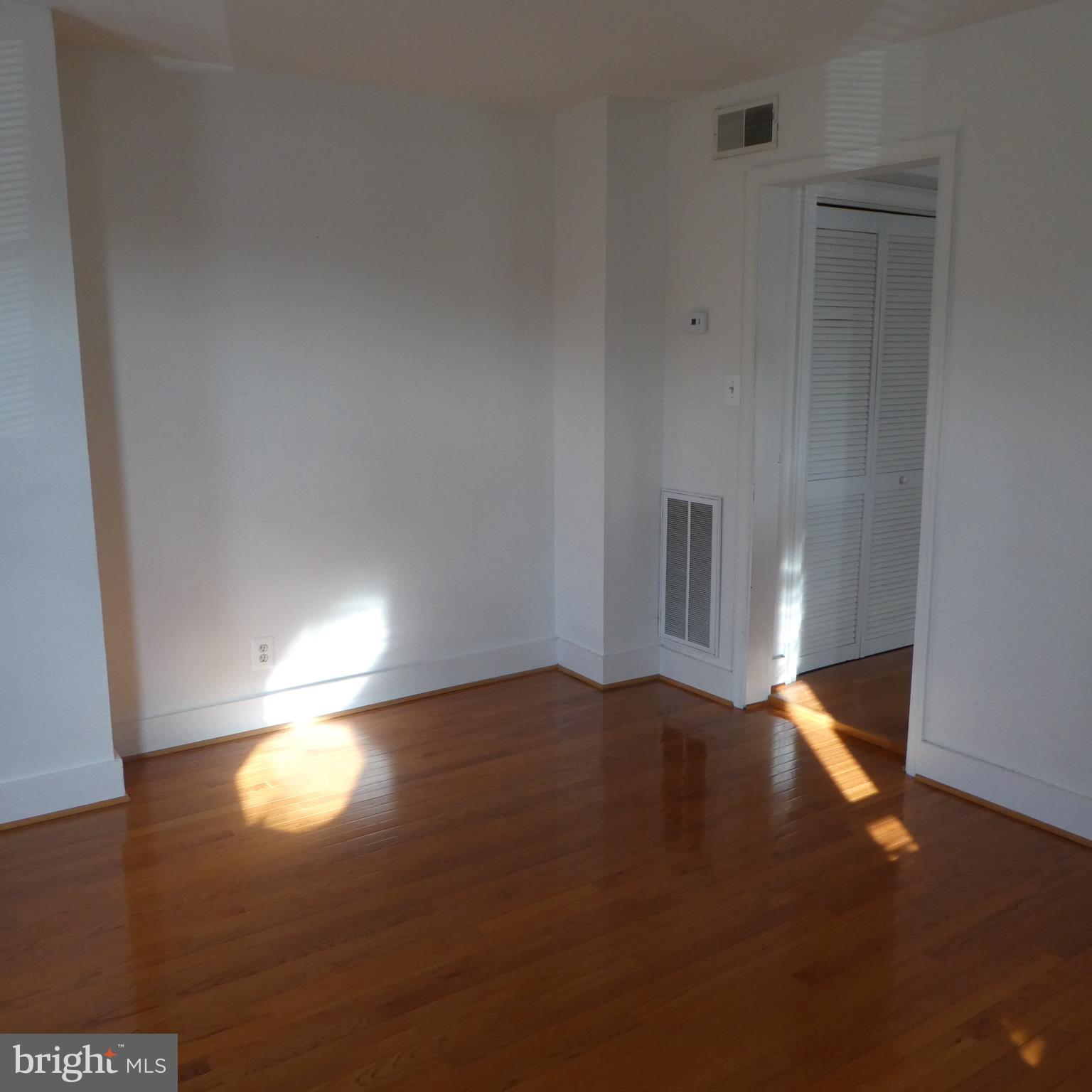408 C Street, Unit 202 Quantico, VA 22134 - Photo 11 of 23 a view of an empty room with wooden floor and a window
