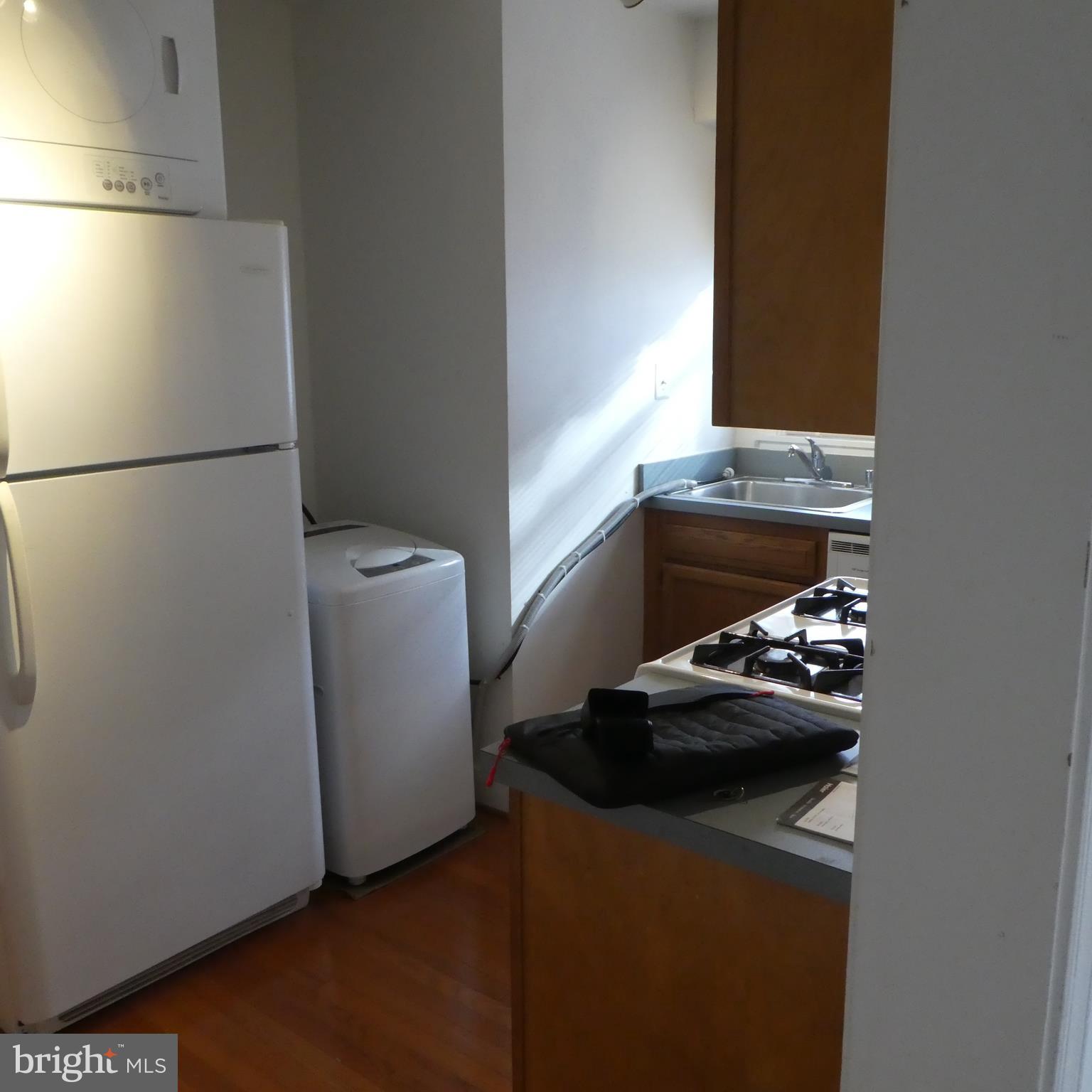 408 C Street, Unit 202 Quantico, VA 22134 - Photo 13 of 23 a room with a refrigerator and a stove