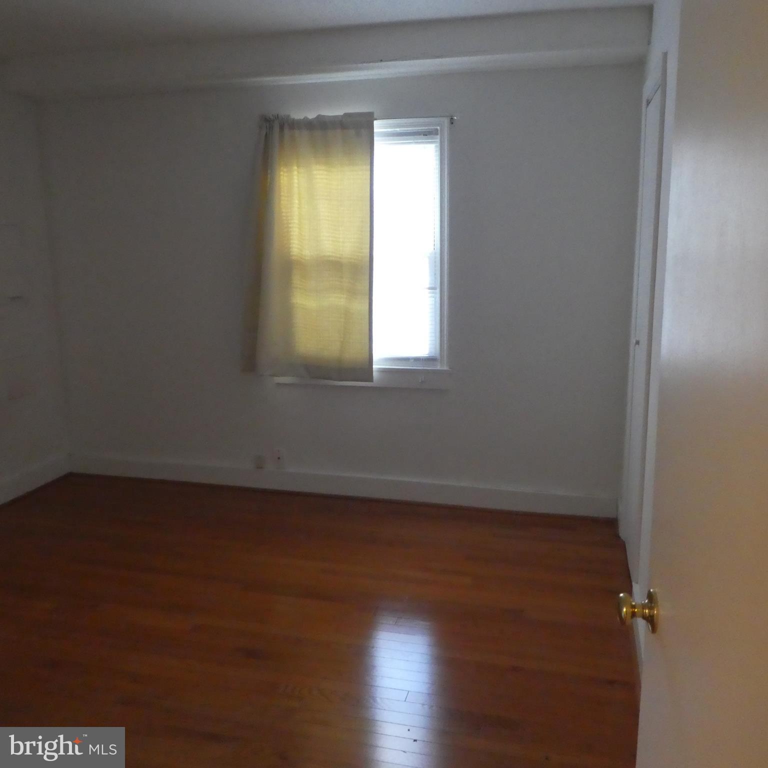 408 C Street, Unit 202 Quantico, VA 22134 - Photo 15 of 23 an empty room with wooden floor and windows