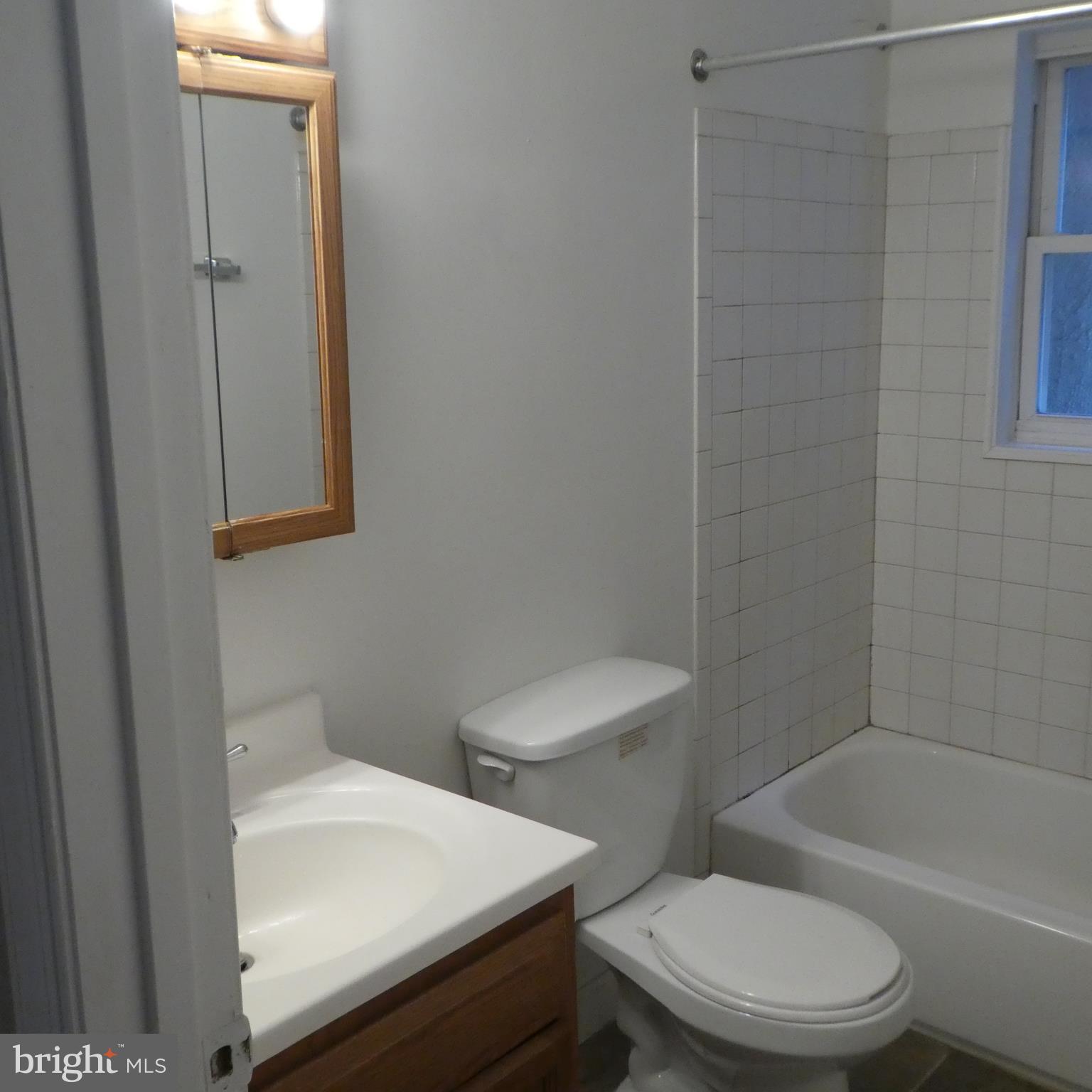 408 C Street, Unit 202 Quantico, VA 22134 - Photo 18 of 23 a white toilet sitting next to a bathroom sink and vanity