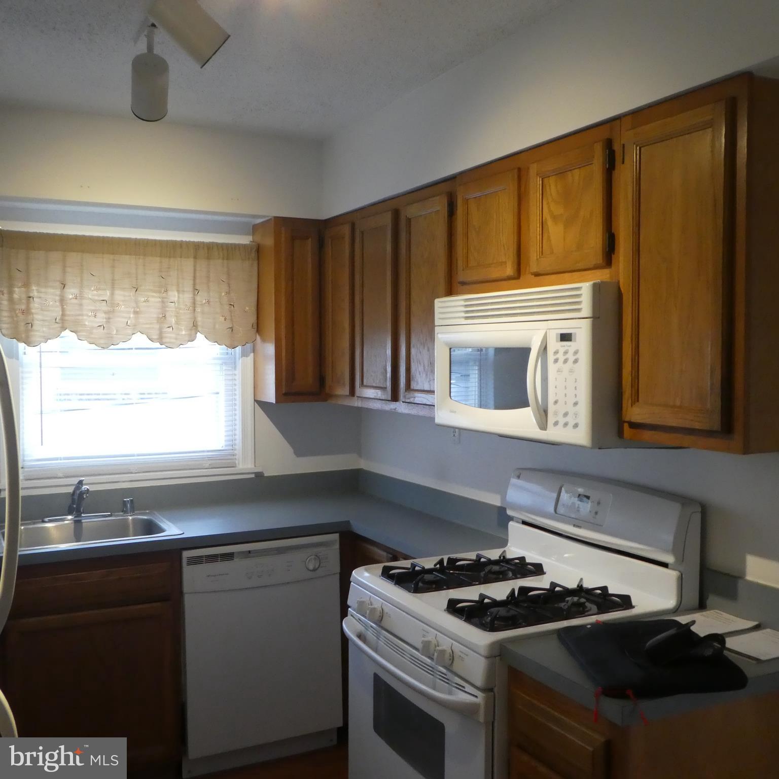 408 C Street, Unit 202 Quantico, VA 22134 - Photo 22 of 23 a kitchen with granite countertop a stove sink and cabinets