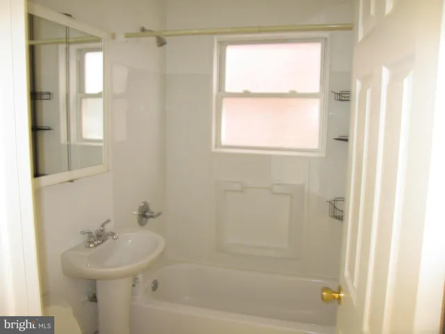 a bathroom with a sink a mirror and a bathtub