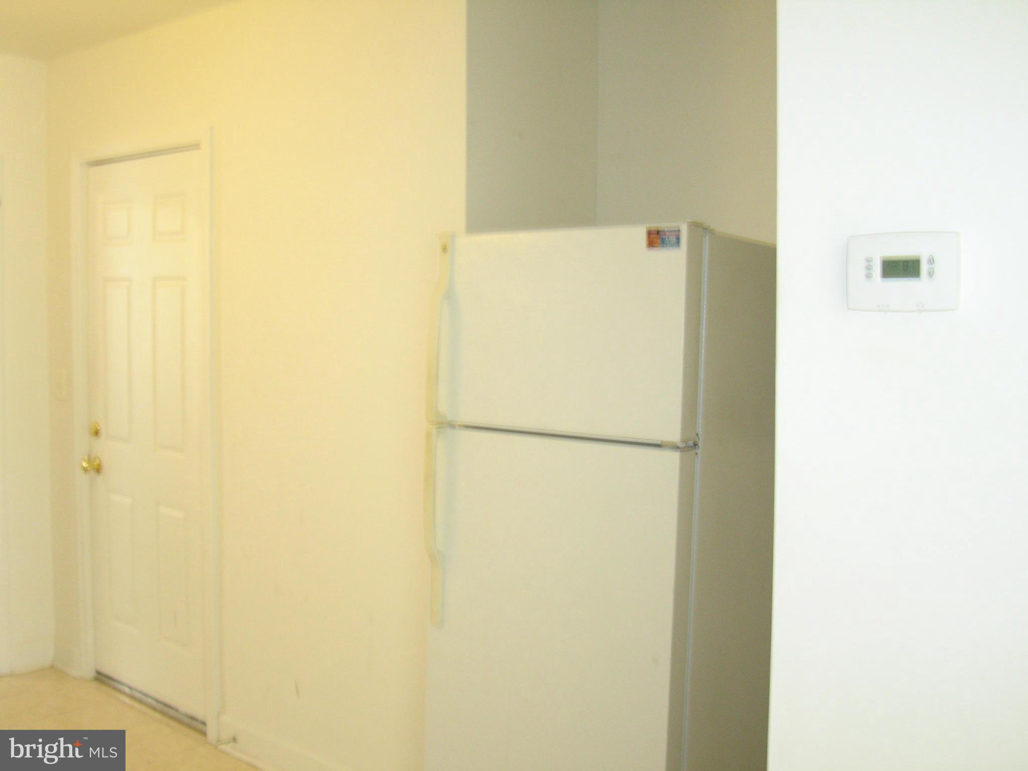 408 C Street, Unit 202 Quantico, VA 22134 - Photo 5 of 23 a white refrigerator freezer sitting next to a white wall