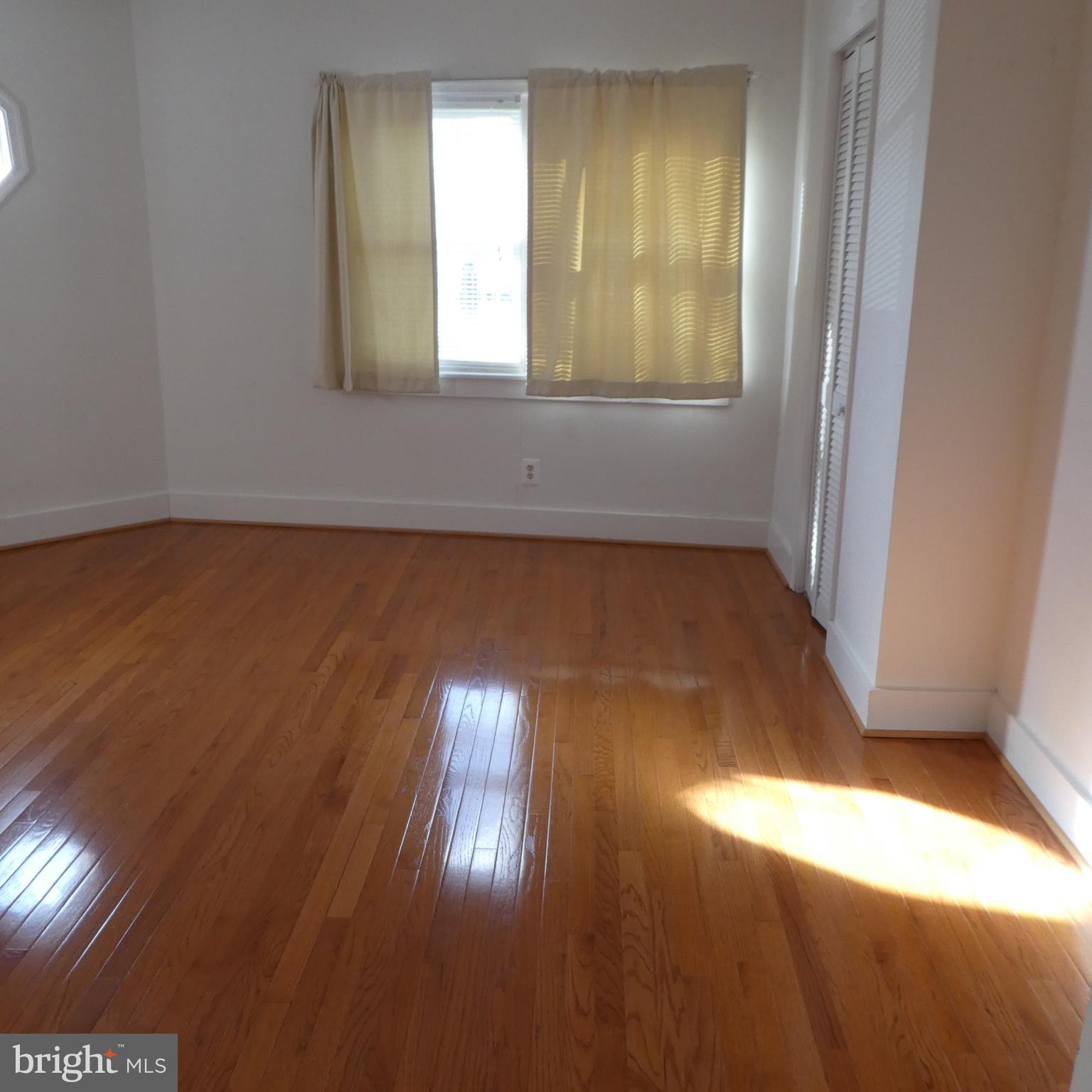 408 C Street, Unit 202 Quantico, VA 22134 - Photo 8 of 23 an empty room with wooden floor and windows