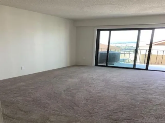 a view of an empty room with a large window