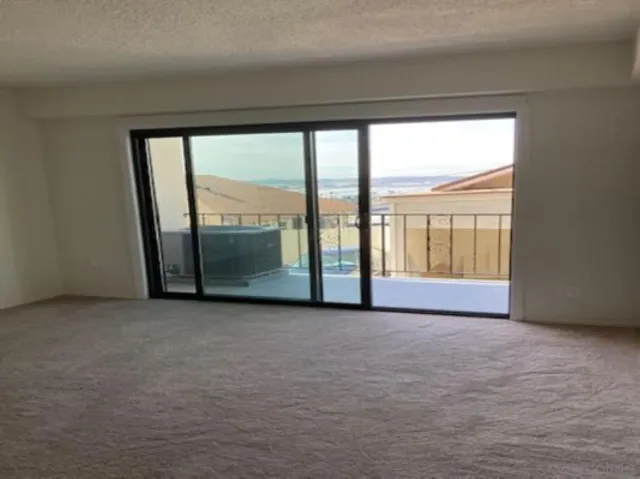 an empty room with closet and a bathroom