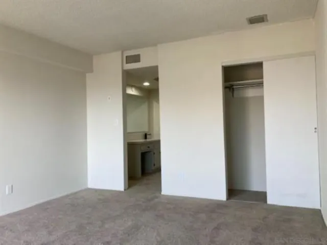 a view of an empty room and closet area