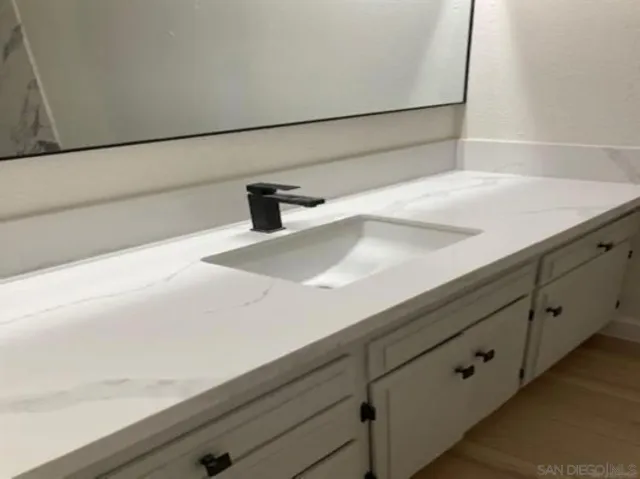 a bathroom with a sink and mirror