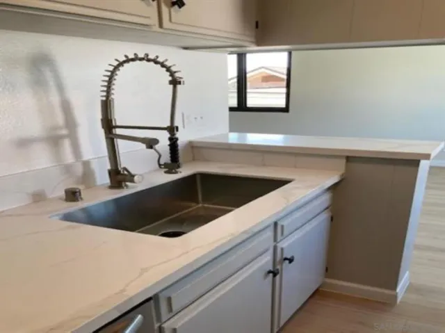 a kitchen with a sink and cabinets