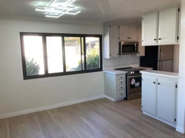 a kitchen with cabinets a sink and appliances