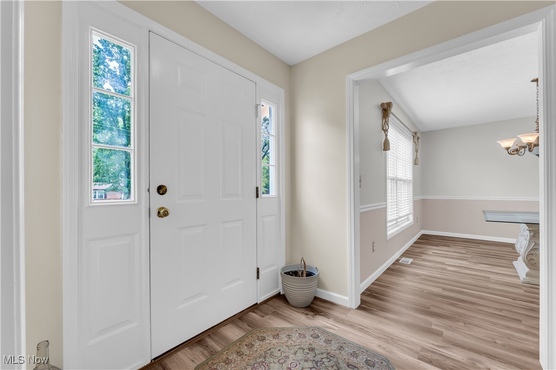 25861 Kennedy Ridge Road North Olmsted, OH 44070 - Photo 5 of 24 Entrance foyer featuring light wood-style flooring, a chandelier, and baseboards