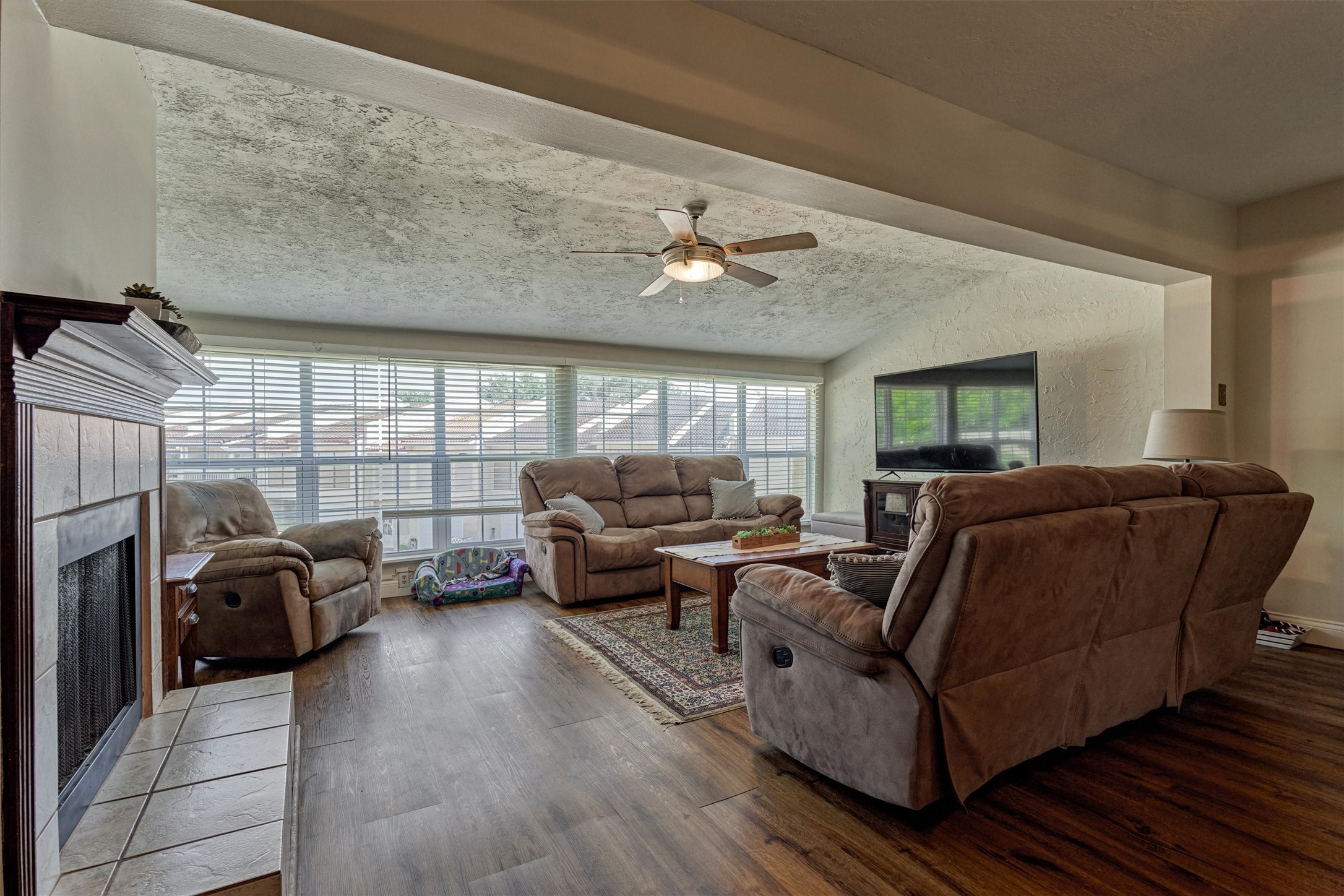 39 Regency Point Conroe, TX 77356 - Photo 16 of 44 a living room with furniture ceiling fan and a rug