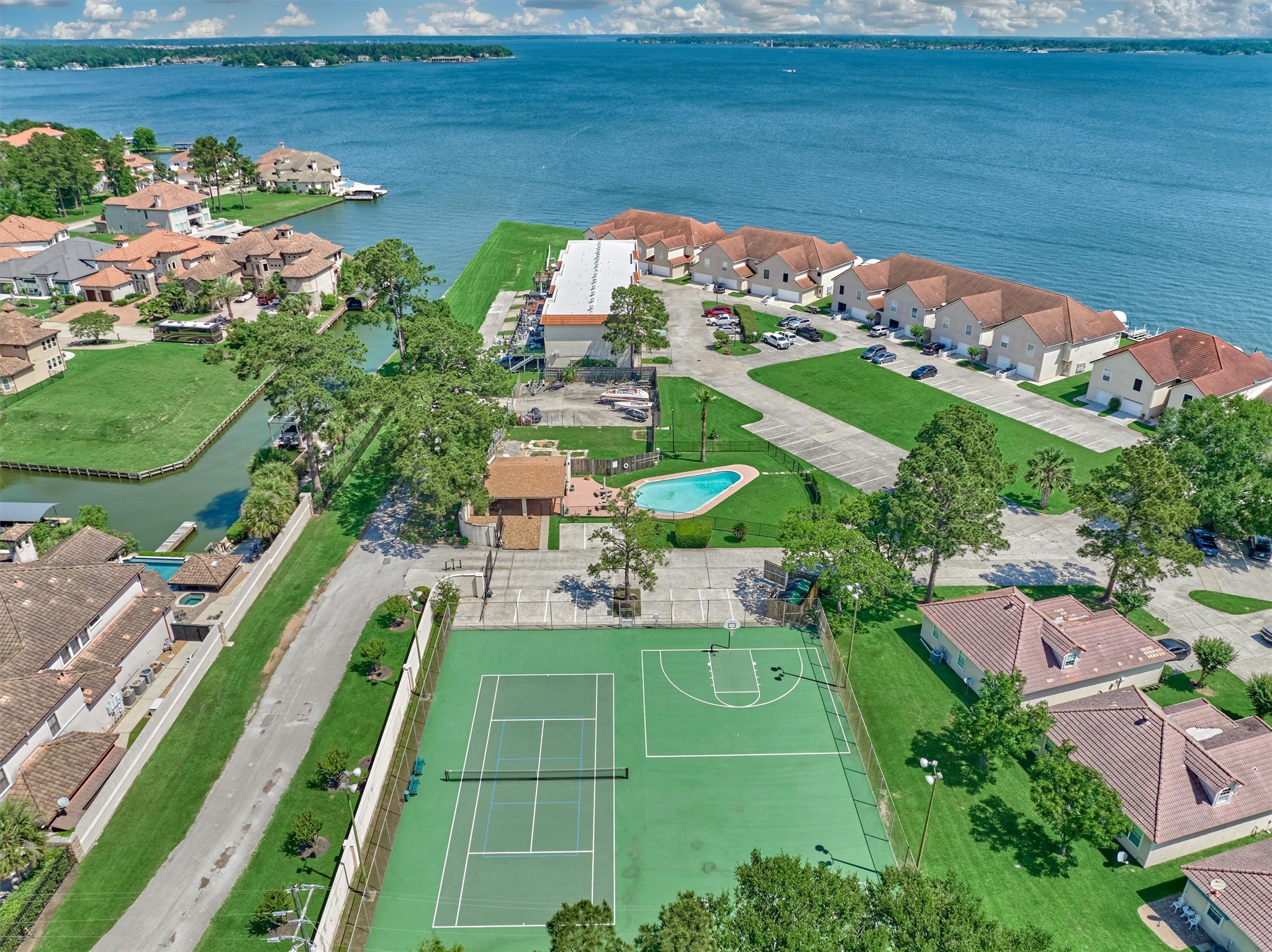 39 Regency Point Conroe, TX 77356 - Photo 2 of 44 an aerial view of a house with a garden and lake view