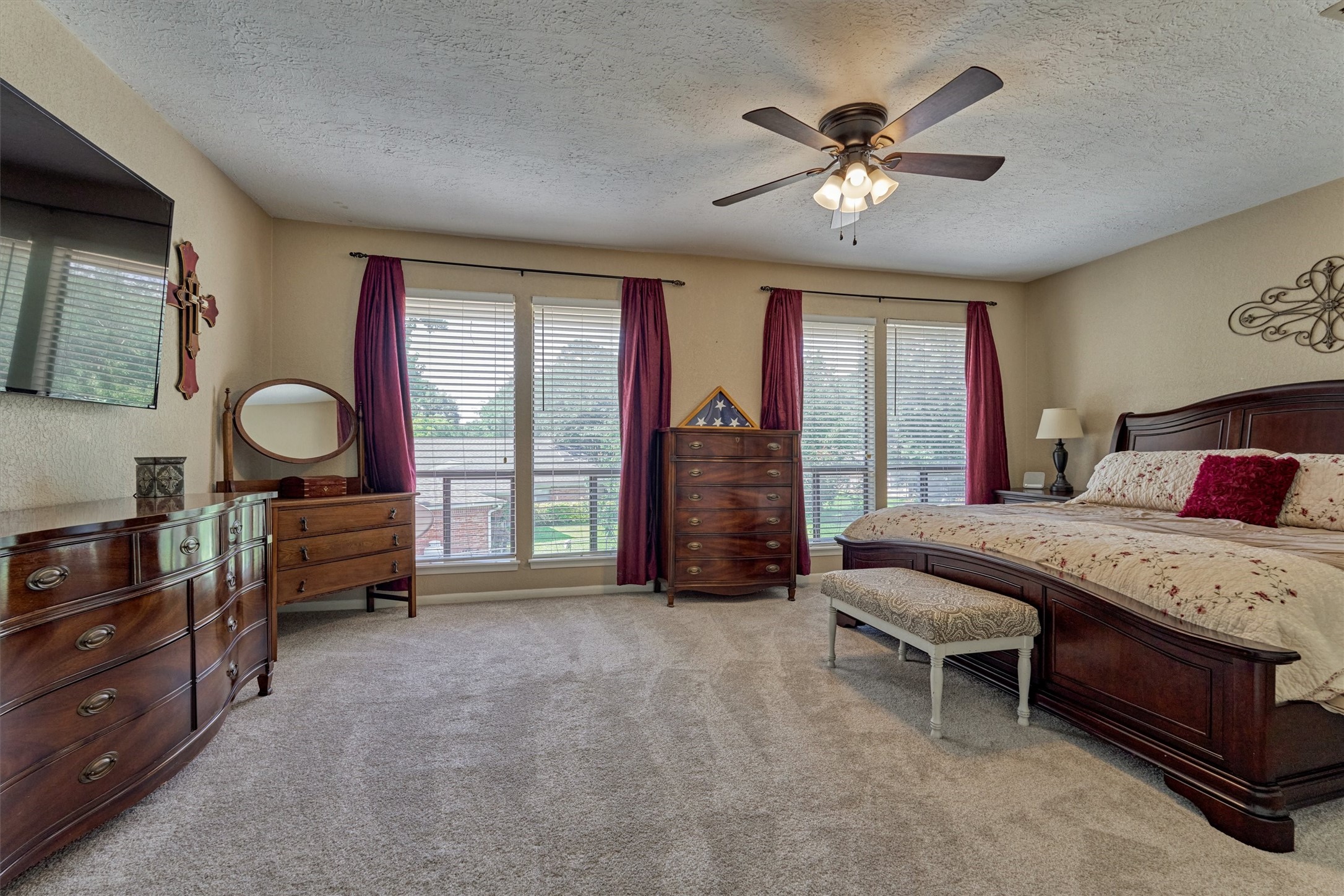 39 Regency Point Conroe, TX 77356 - Photo 25 of 44 a bedroom with a bed and a chandelier