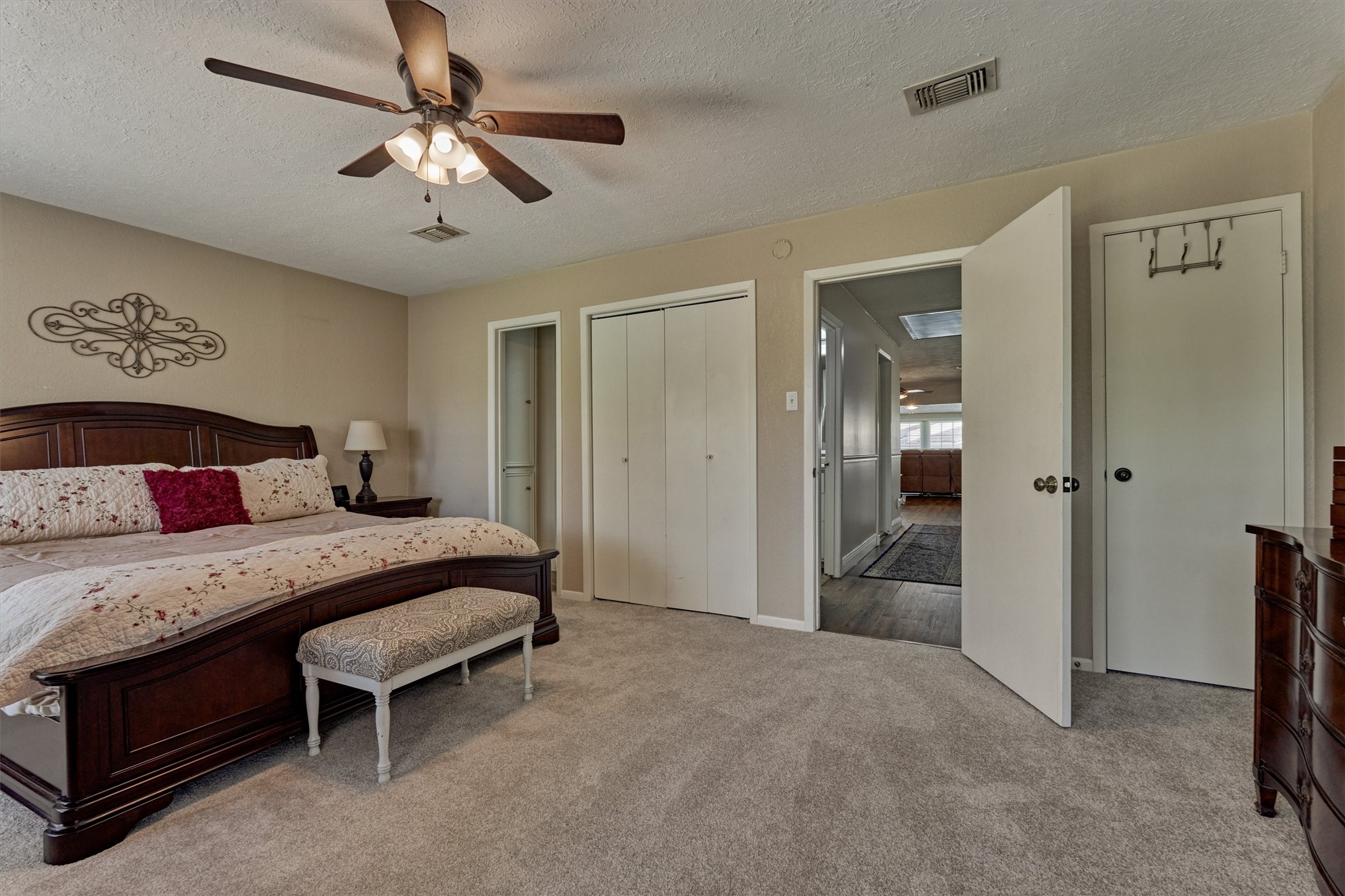 39 Regency Point Conroe, TX 77356 - Photo 27 of 44 a bedroom with a bed and a chandelier